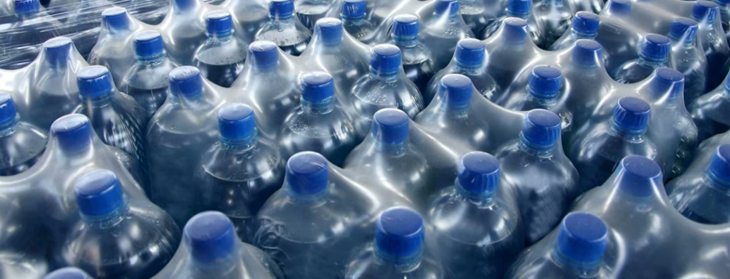 Shrink film applied over a set of water bottles for secure packaging and protection.